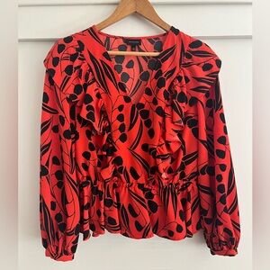 Orange-red top with black floral print